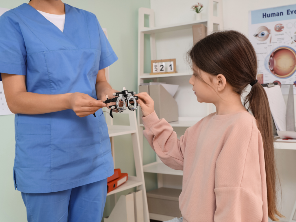 Girl in eye doctors office, looking at eye gear