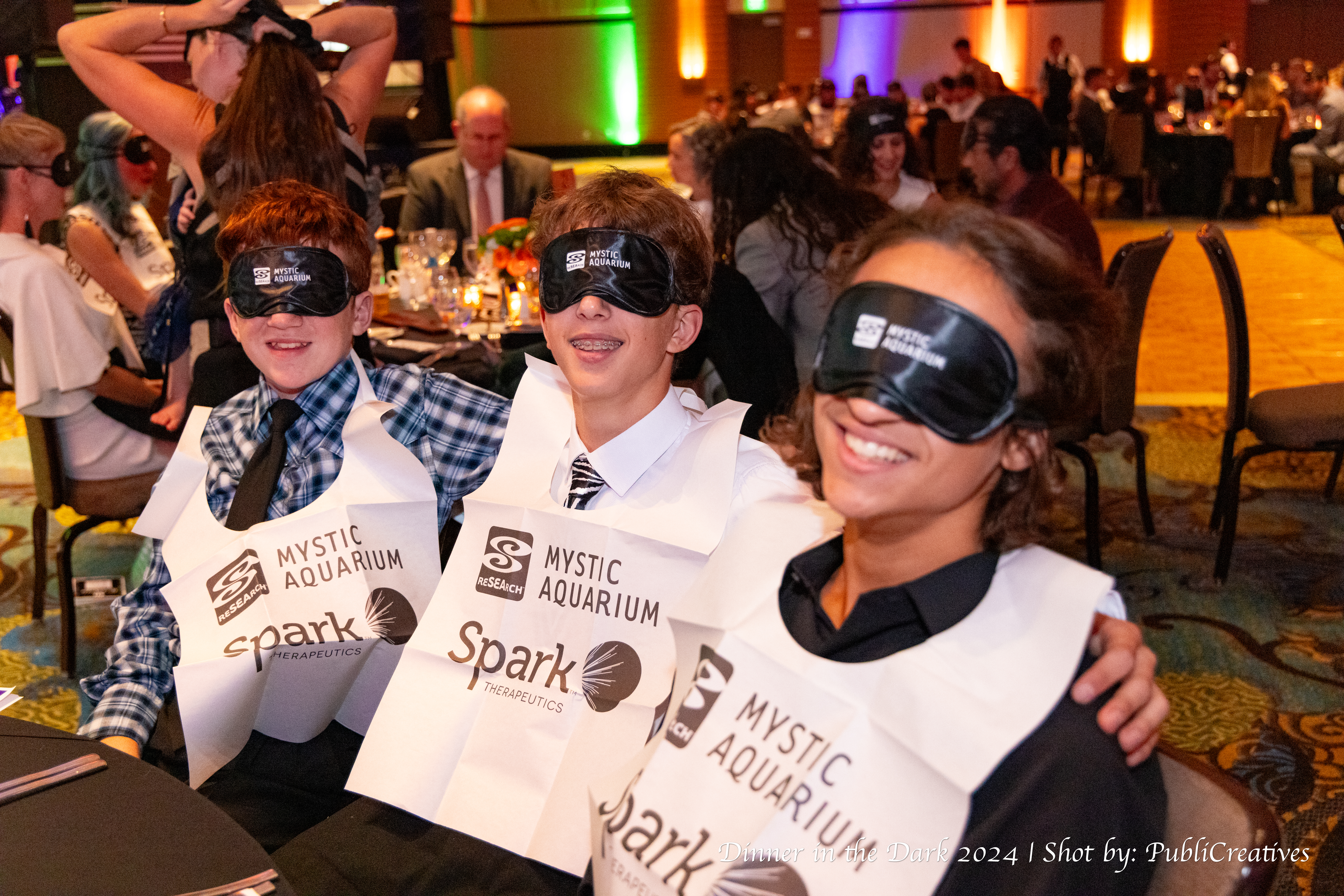 Attendees blindfolded with bibs on during previous Dinner in the Dark