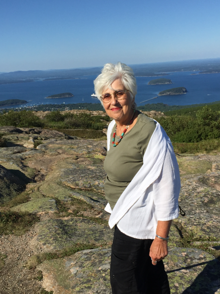 Judith outside with water behind her