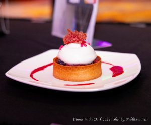 Flaky crust with mixed berries. On top, a dollop of whipped cream.