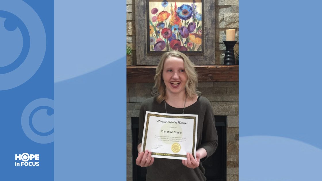 Kristen holding up her certificate