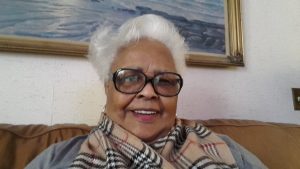 head shot of older black woman with white hair and glasses.