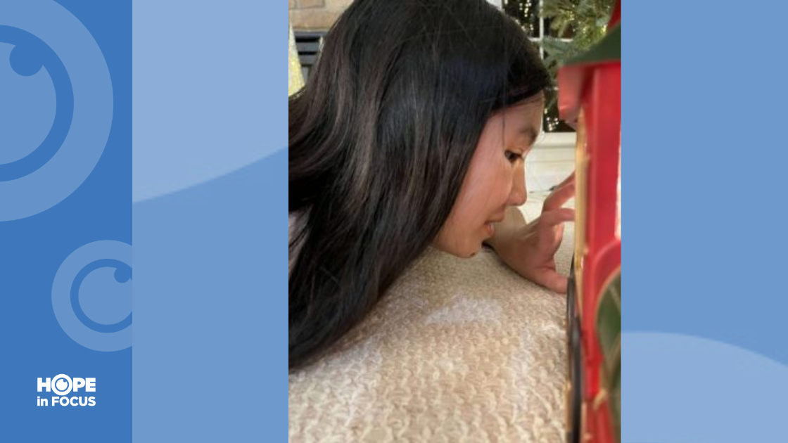 Naomi looking at Christmas ornament