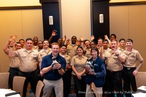 The Navy with the Mystic Aquarium staff, holding up the two penguins.