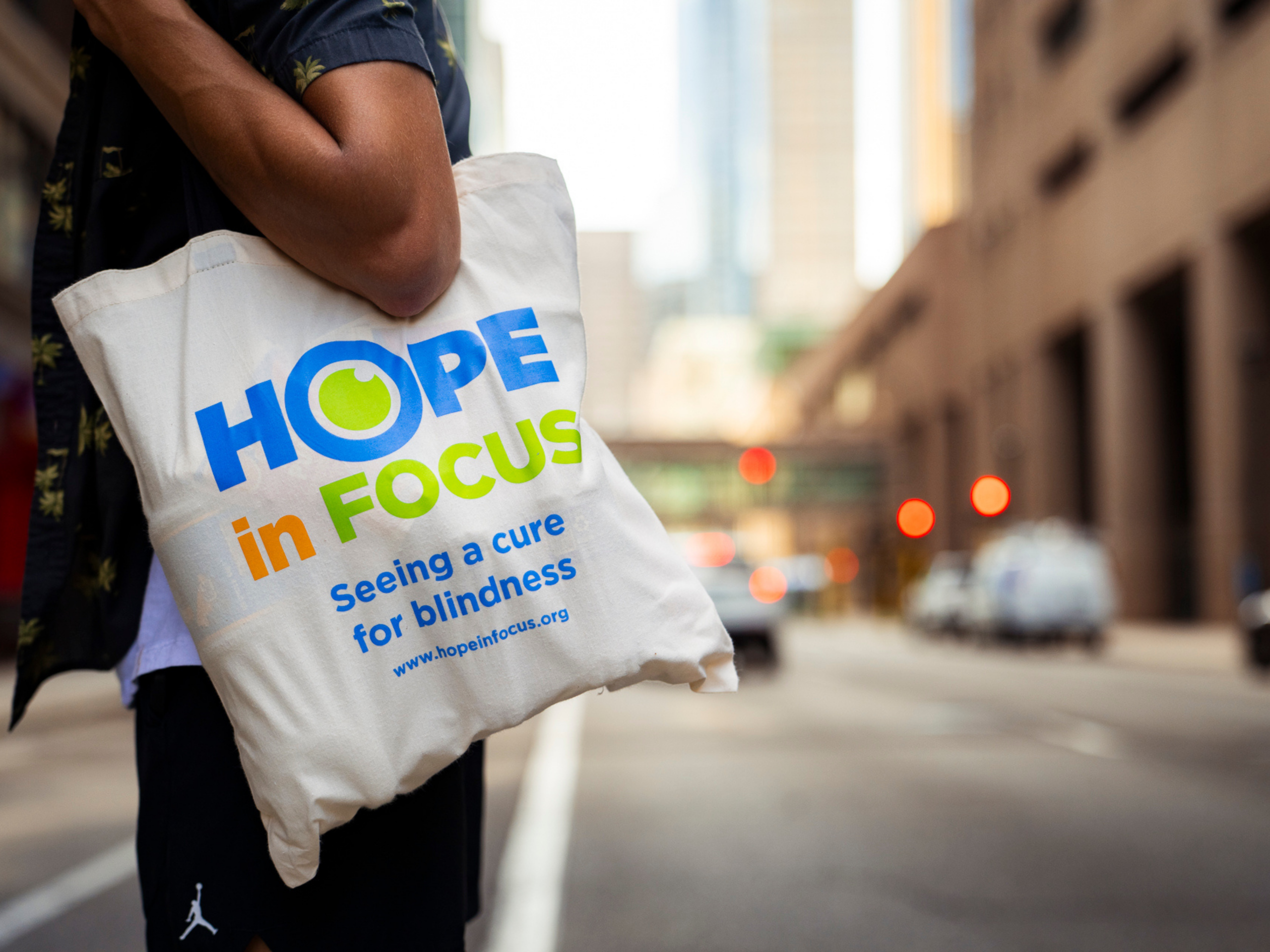 Hope in Focus bag with city Minneapolis city behind it
