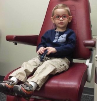Elliot Wolf sitting in a medical exam chair