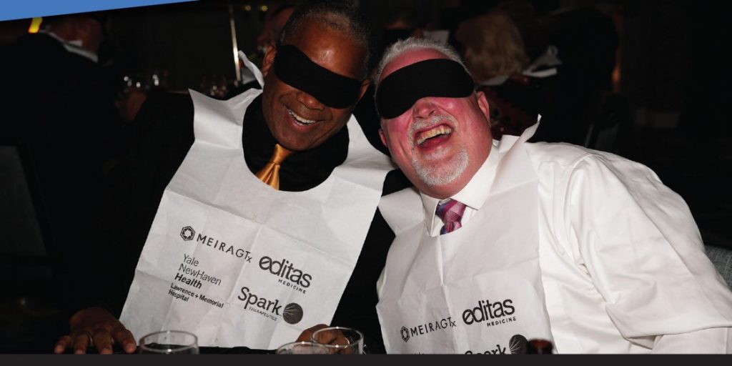 Two men in blindfolds and bibs