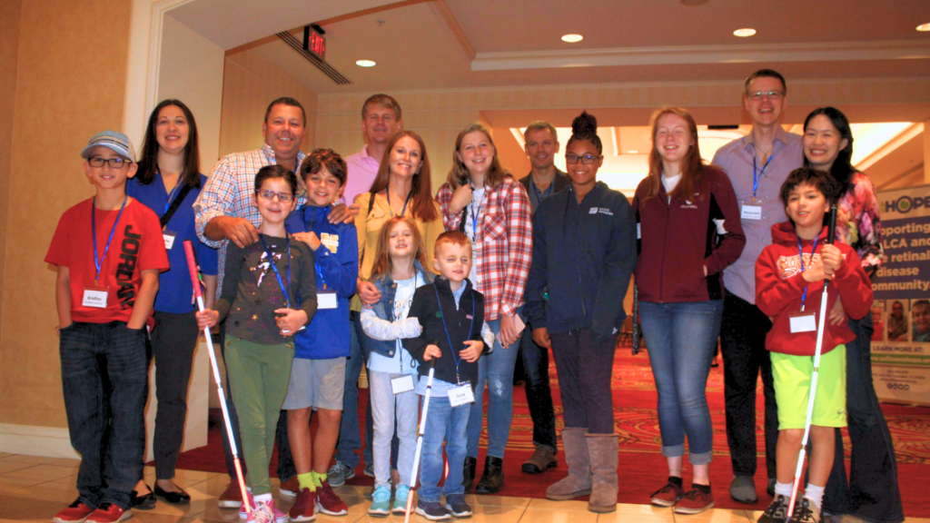 Children with canes and their parents smiling