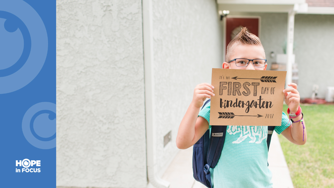 Maverick Johnston holding up a sign saying "it's my First day of kindergarden"