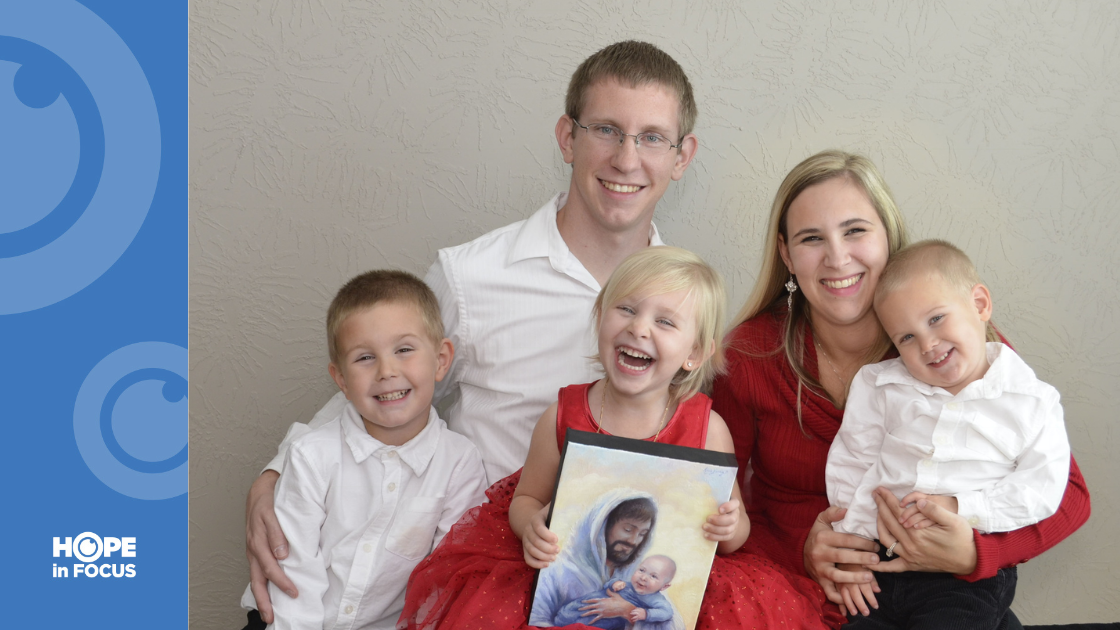 Mikayla and Andrew Larson with Conner (L), Aubrie (holding painting of little brother Liam who passed away from SIDS) and Carter.