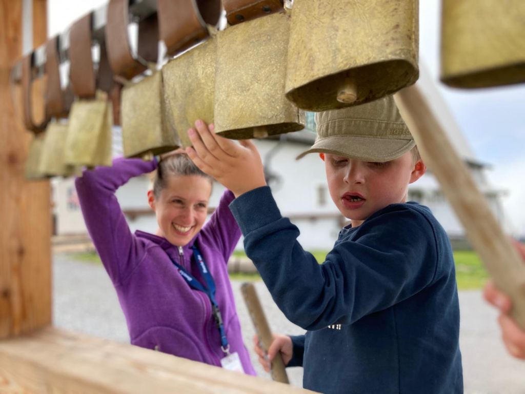 Laura and Enzo playing with large bells 