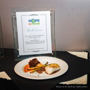 The fourth course, non vegan with a Hope in Focus sign behind it