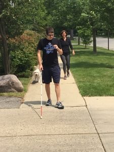 Alan Brint, who is blind, is trailed by his mother Betsy and his dog Mo, tries out his new Aira glasses. 