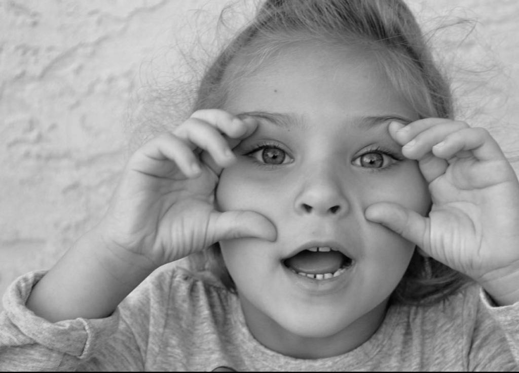 Monroe with her hands near her eyes