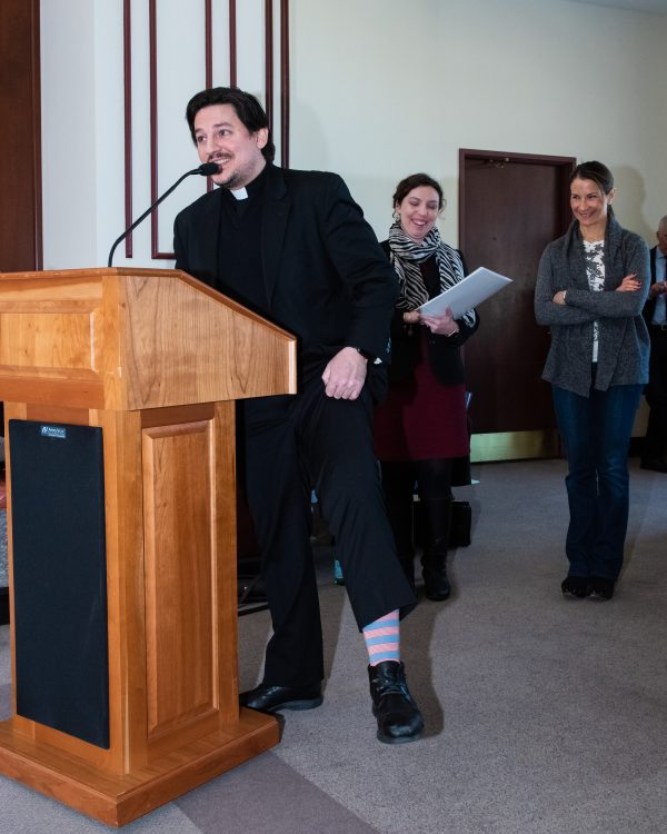 Father Nikolas Karloutsos at the podium