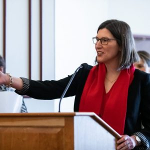 Alissa at the podium mid speech