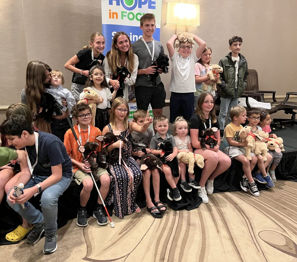 A mix of kids and caregivers attending the 2023 Hope in Focus LCA Family Conference in Indianapolis