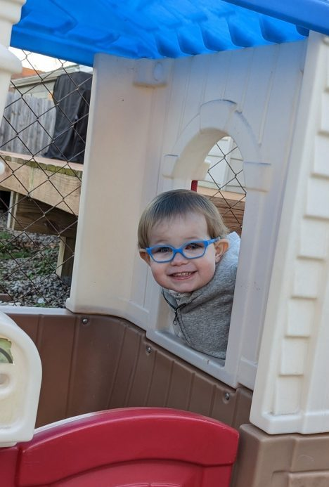 Atlas poking his head out of a playhouse. 