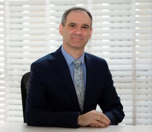 Prof. Michel Michaelides in a black suit