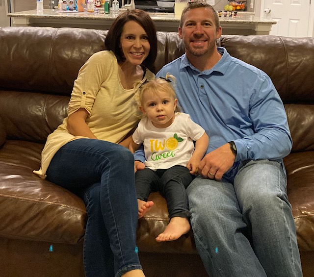 Mom (L) with Dylan and Dad (R) sitting on a brown couch