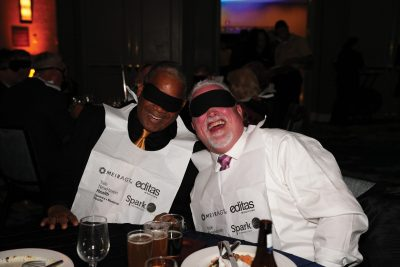 Two guests with their blindfolds and bibs on
