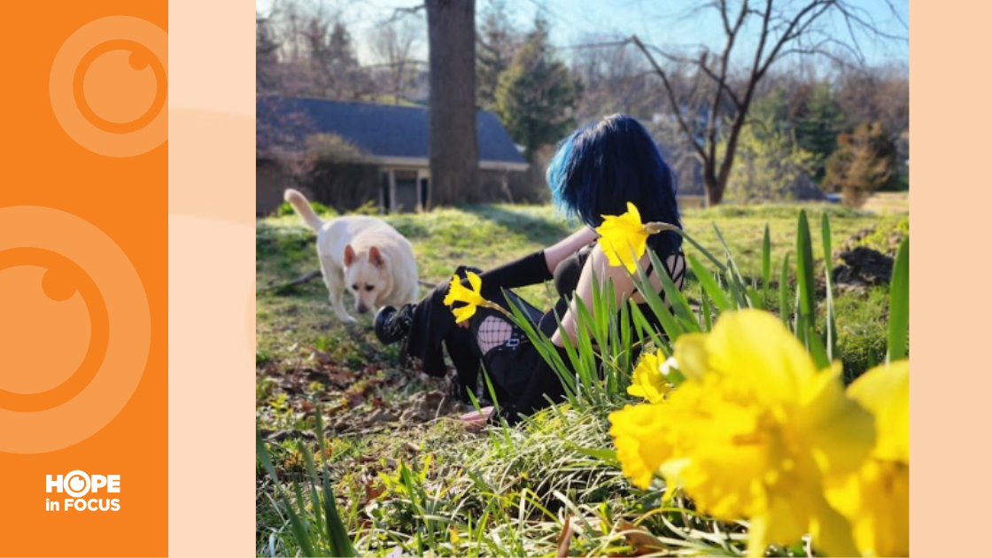 Ashley and her dog in the grass