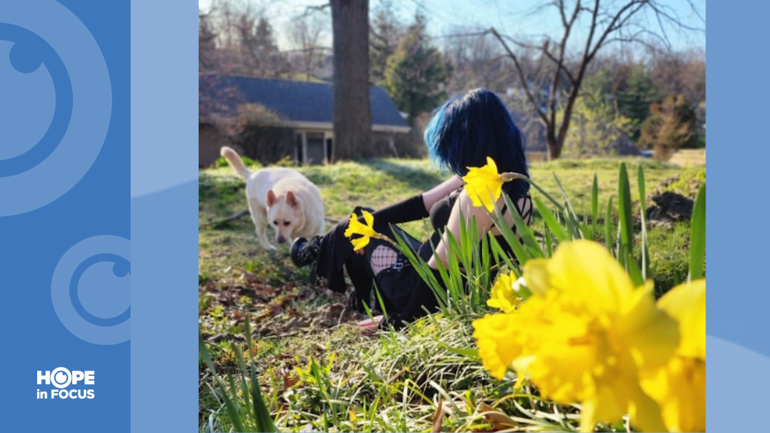 Ashley and her dog in the grass