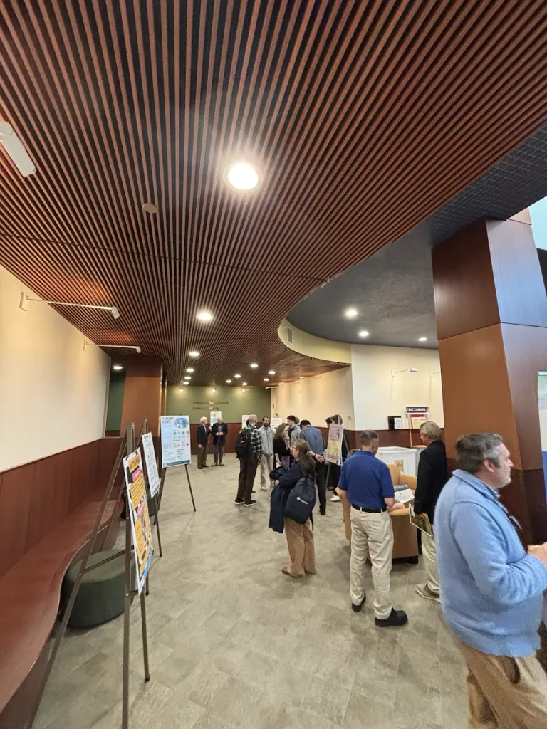 Attendees looking at posters in lobby